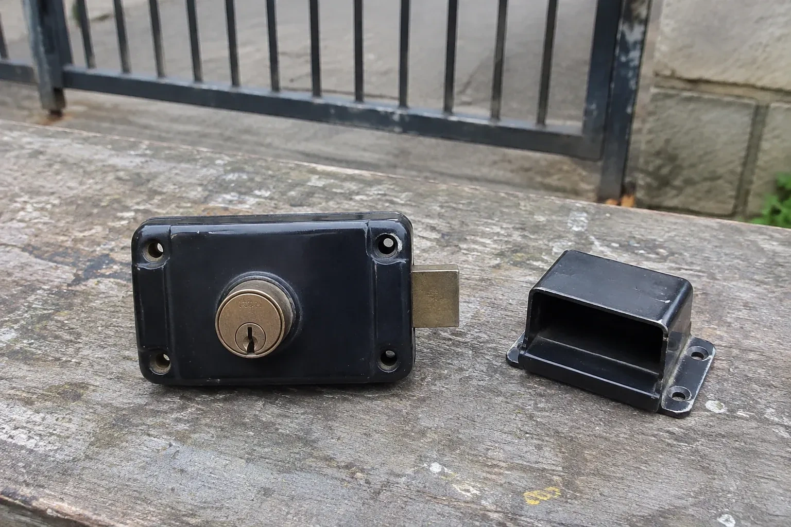 Detached rim gate lock and separate box keeper on an outdoor workbench. — Gate & Building Entry Locks, London